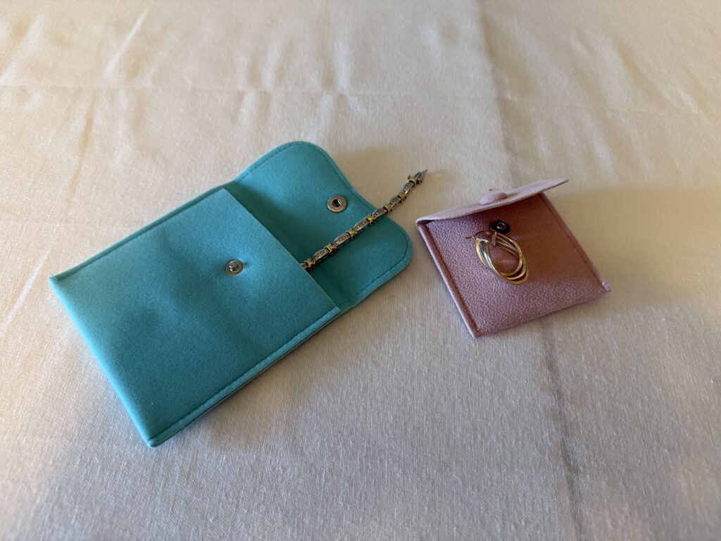 Velvet jewelry pouches in assorted colors with snap closure, soft storage for rings, earrings, necklaces