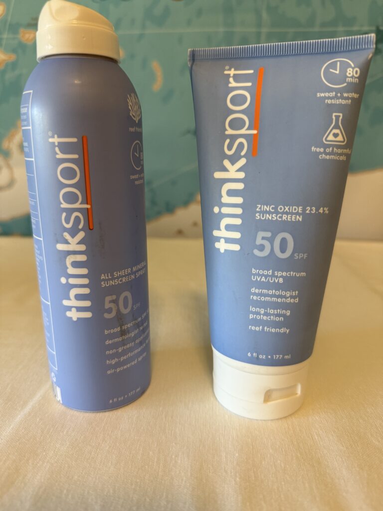 Reef-safe mineral sunscreen bottle, free of oxybenzone and octinoxate, for skin and coral reef protection.