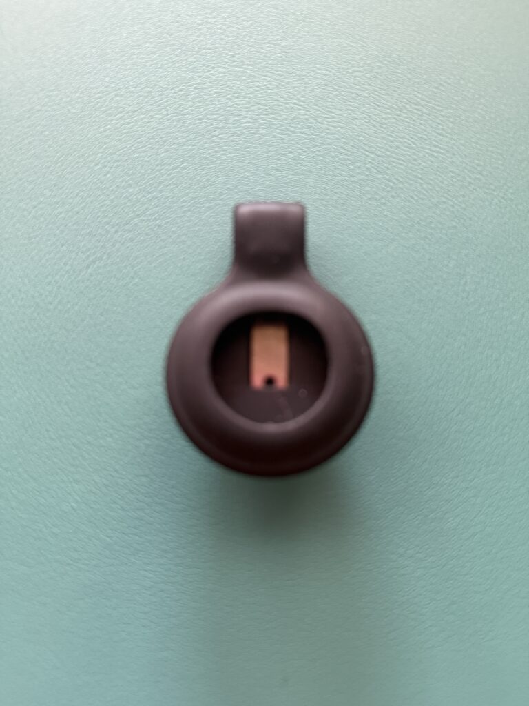 Black clip-style Medallion holder accessory. Clip to a shirt, handbag, etc.